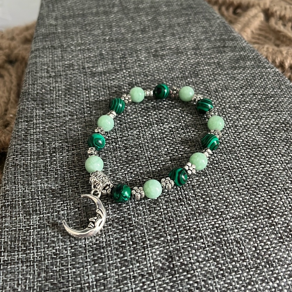 Glass multi toned green beaded flower crescent moon pendant stretch bracelet